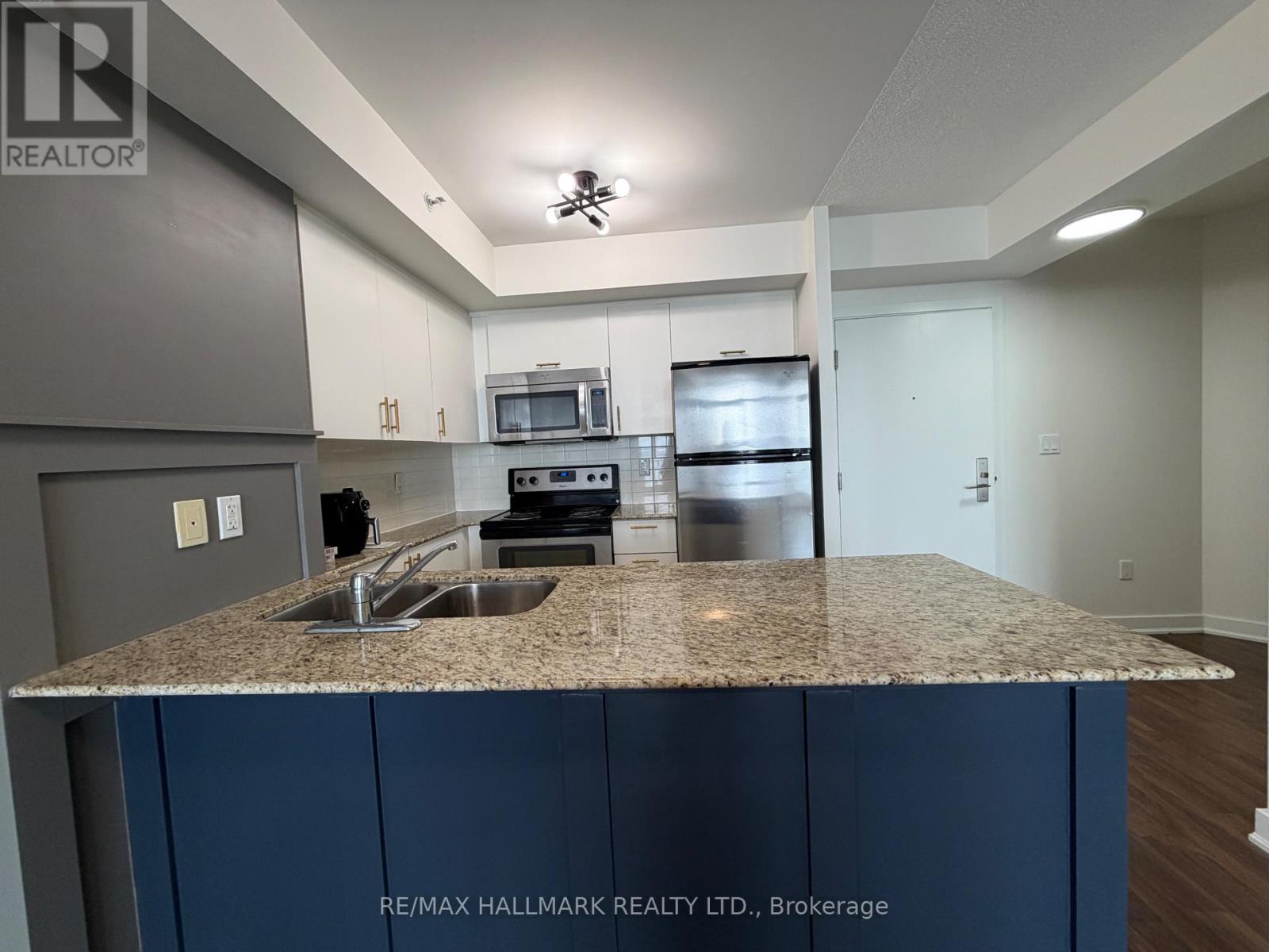 A kitchen with granite countertops and stainless steel appliances.