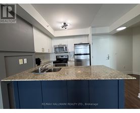 A kitchen with granite countertops and stainless steel appliances.