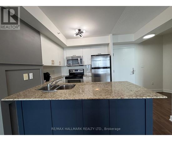 A kitchen with granite countertops and stainless steel appliances.