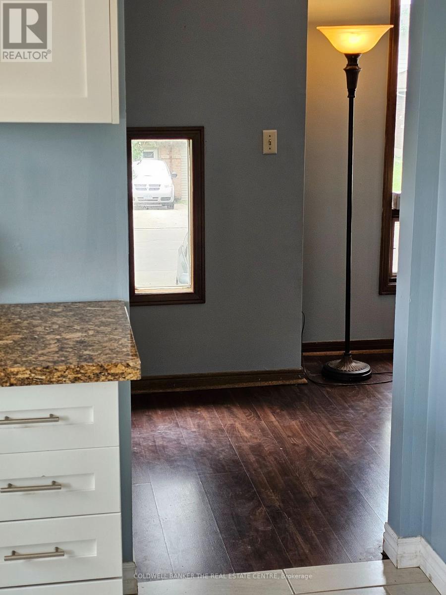 A brown floor in a room with a marble counter top.
