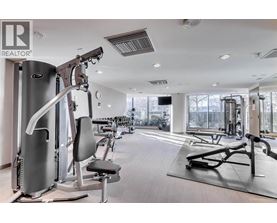 A gym with a variety of equipment including a treadmill, a stationary bike, and a rowing machine.