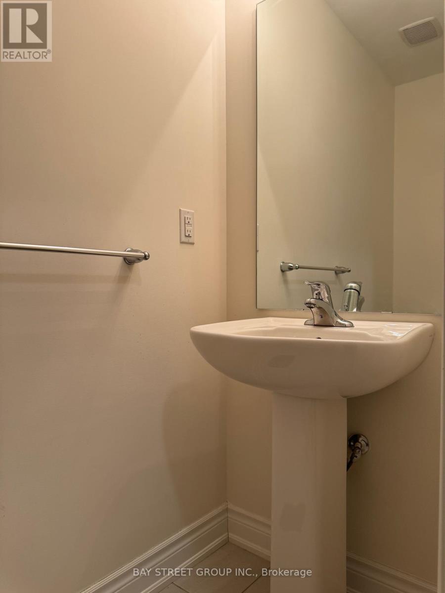 A white sink in a small bathroom.