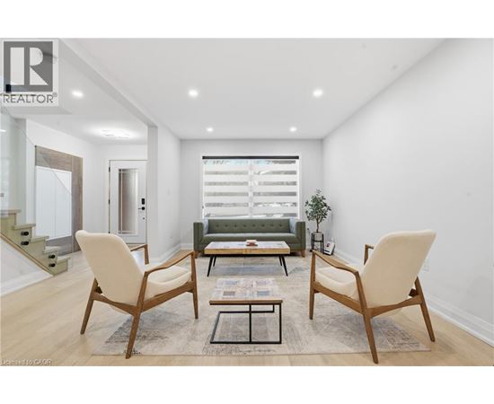 A living room with a sofa, two chairs and a coffee table.
