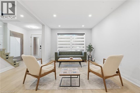 A living room with a sofa, two chairs and a coffee table.