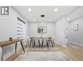 A dining room with a wooden table and chairs.