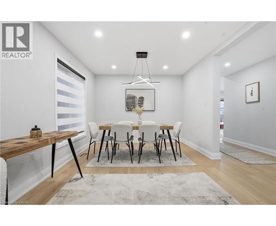 A dining room with a wooden table and chairs.