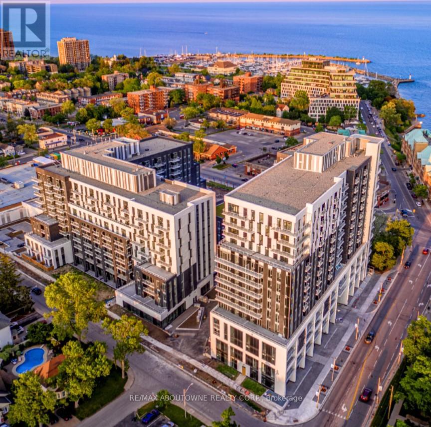 A bird's eye view of a city with apartment buildings and a pool in the foreground.