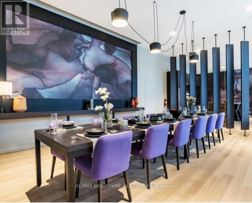 A dining room with a long table set for a meal.