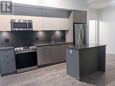 A modern kitchen with a stainless steel oven and microwave above the stove.