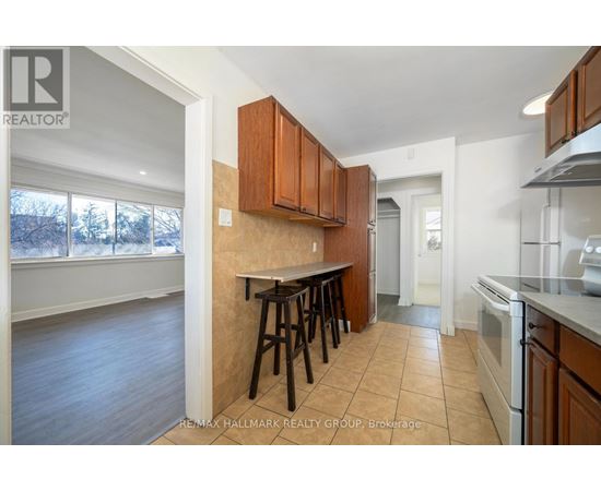 A kitchen with brown cabinets and a white oven.
