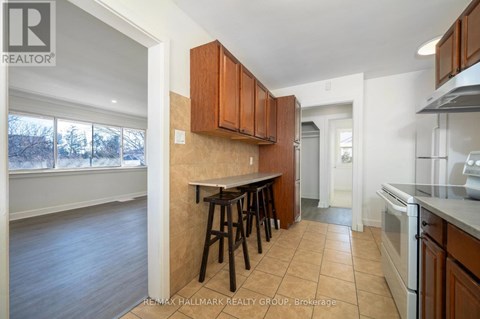 A kitchen with brown cabinets and a white oven.