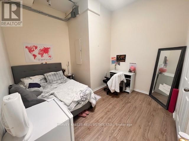 A bedroom with a bed, desk, and chair.