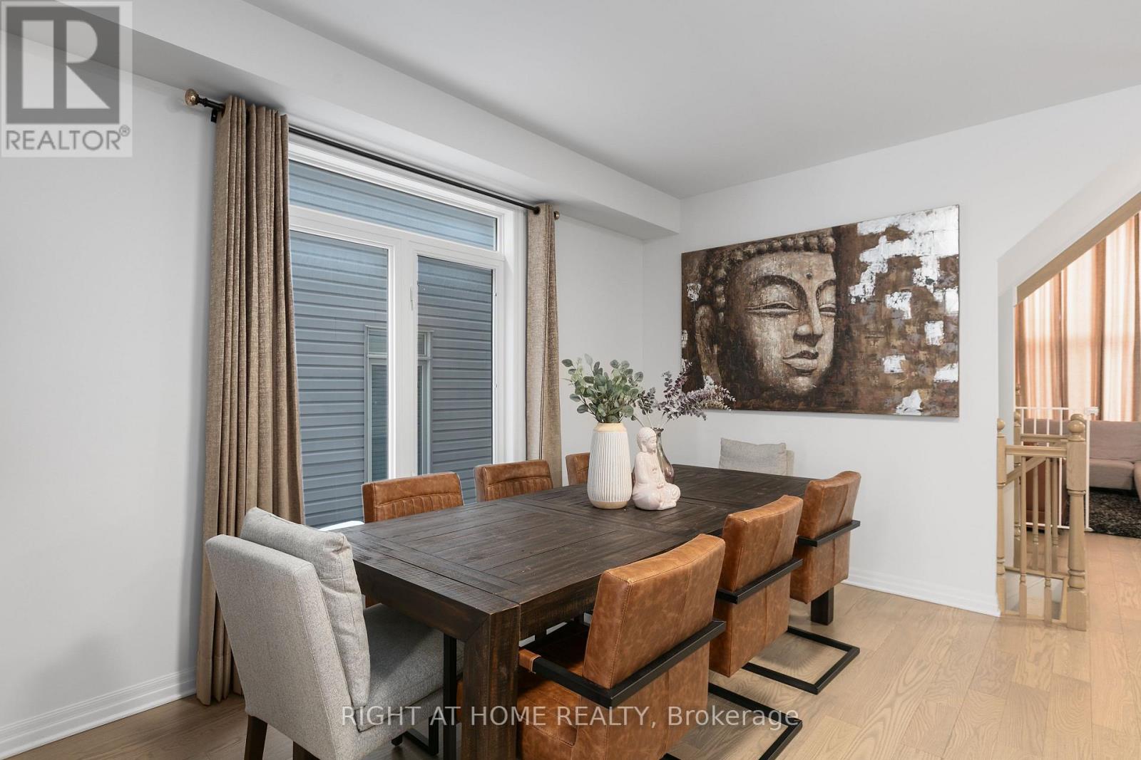 A dining room with a wooden table and chairs.