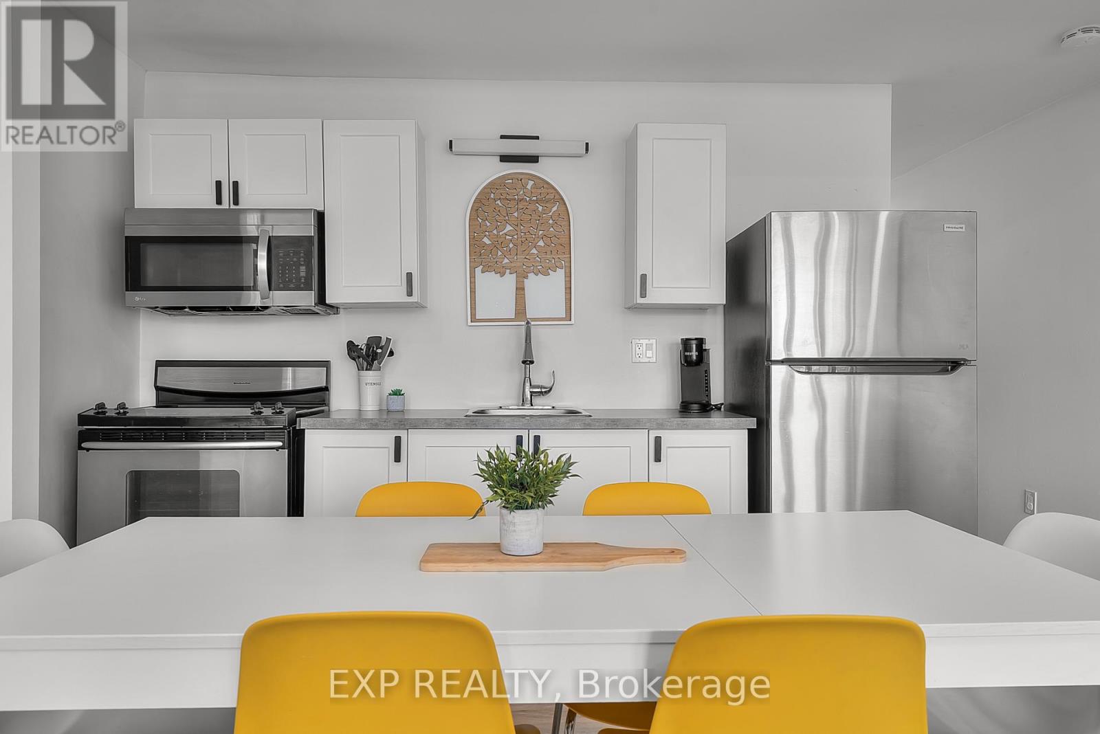 A modern kitchen with white cabinets and a large island.
