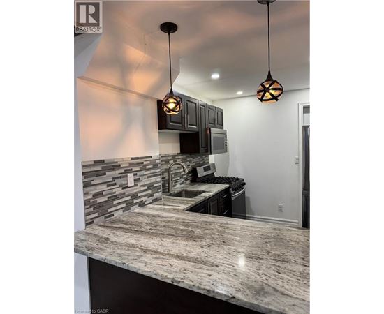 A kitchen with a granite countertop and a modern design.