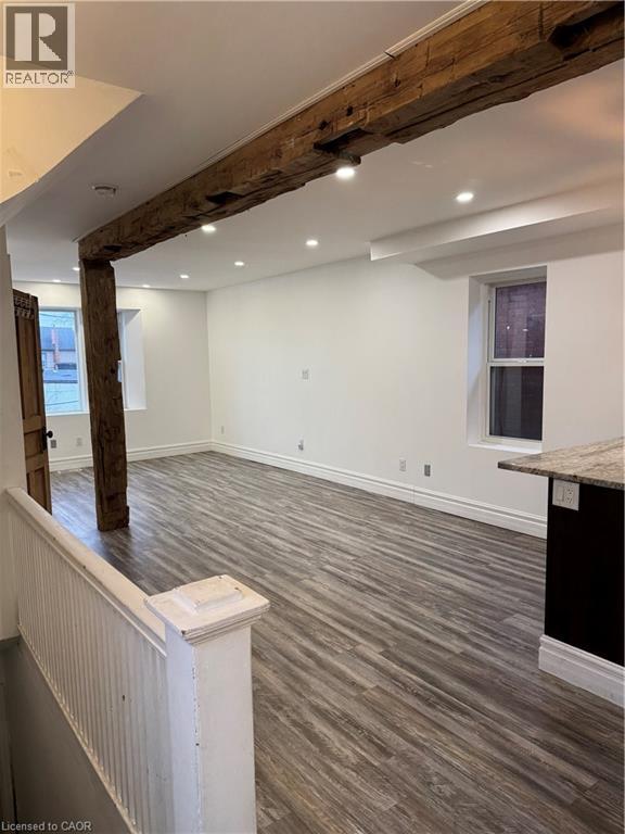 A room with wooden beams on the ceiling and a window on the wall.