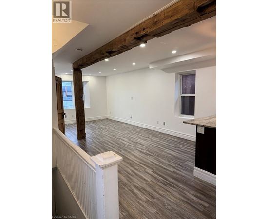 A room with wooden beams on the ceiling and a window on the wall.