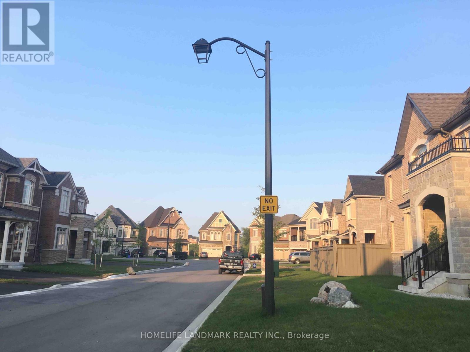 A street view of a residential area with a "NO PARKING" sign.