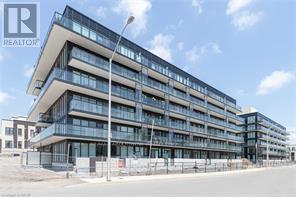 A modern multi-story building with a glass facade and balconies.