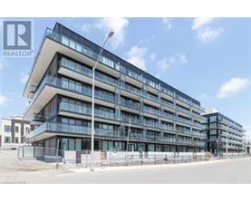 A modern multi-story building with a glass facade and balconies.