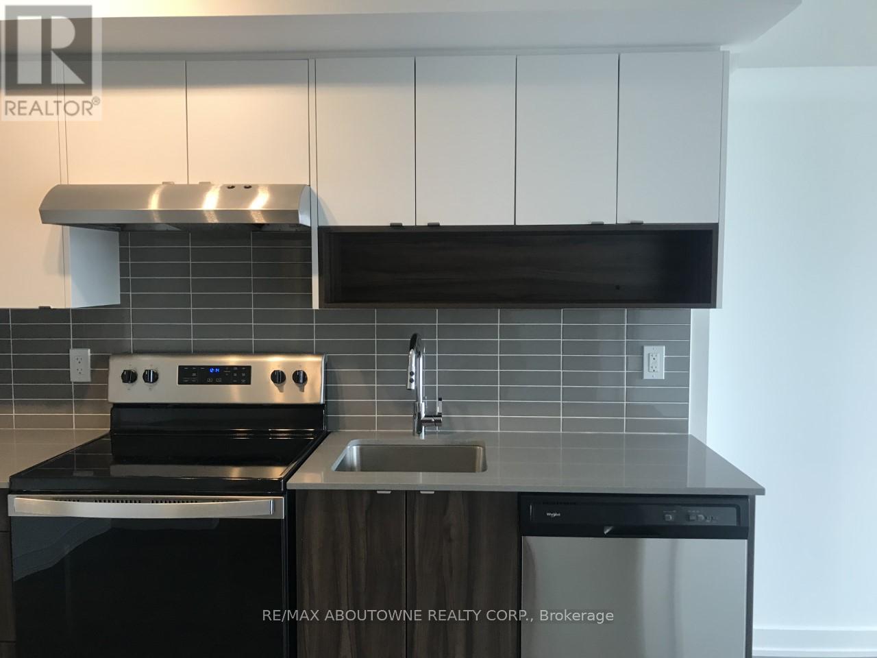 A modern kitchen with a stove top oven and a dishwasher.