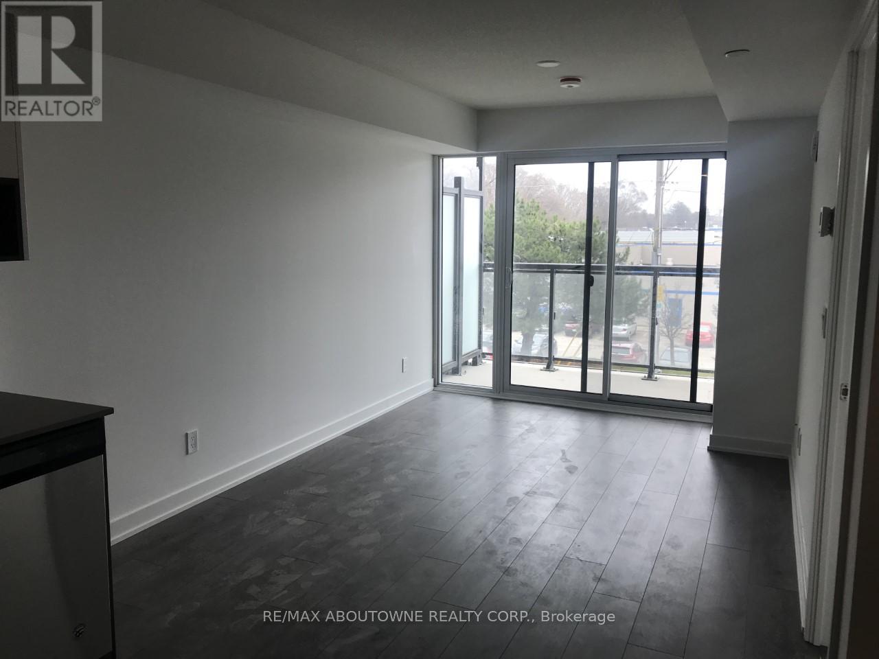 A spacious room with a view of the outside through the glass doors.