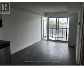 A spacious room with a view of the outside through the glass doors.
