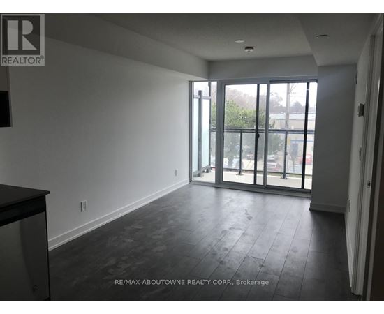 A spacious room with a view of the outside through the glass doors.