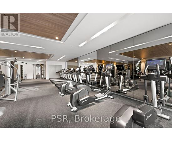 A gym with a variety of equipment including treadmills, weights, and exercise machines.