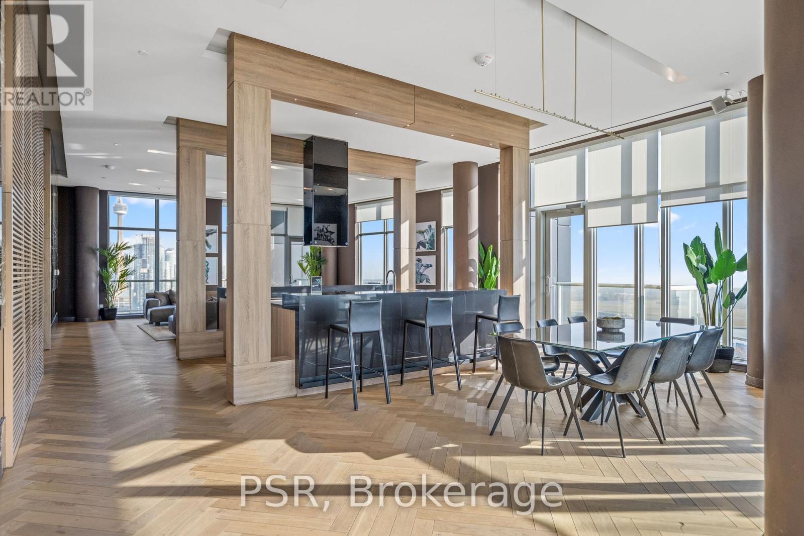 A modern dining room with a large table and chairs.