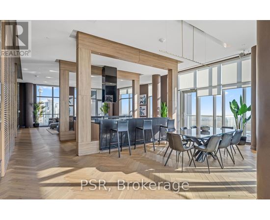 A modern dining room with a large table and chairs.