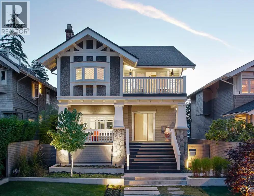 A modern house with a large front porch and a balcony.