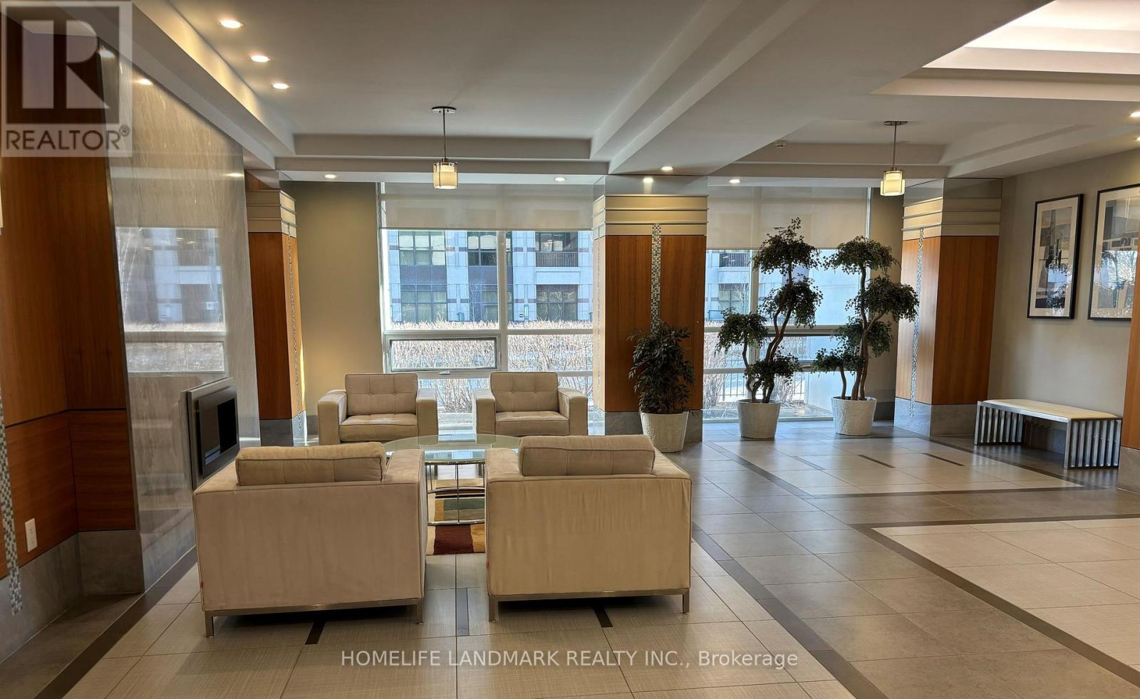 A spacious lobby with a reception desk and comfortable seating areas.