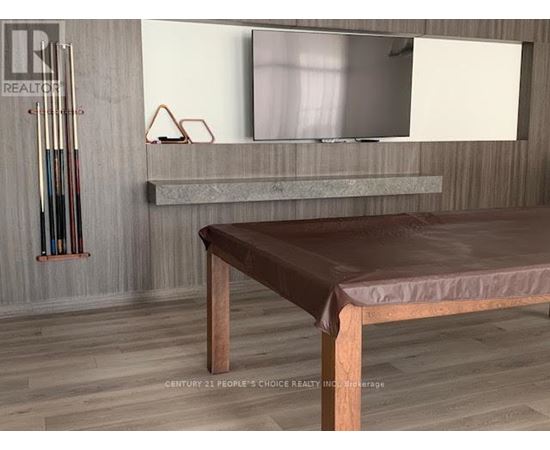 A modern living room with a brown leather sofa and a grey countertop.