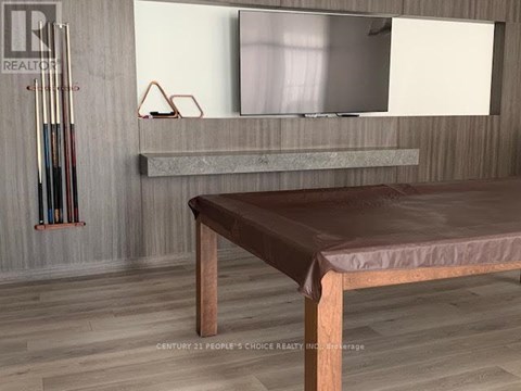 A modern living room with a brown leather sofa and a grey countertop.