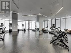 A gym with a row of treadmills and a sign that says REALTOR.