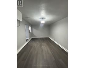 A room with a wooden floor and a white ceiling.