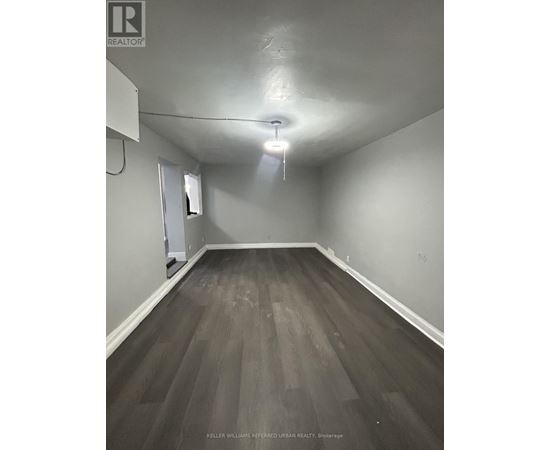 A room with a wooden floor and a white ceiling.