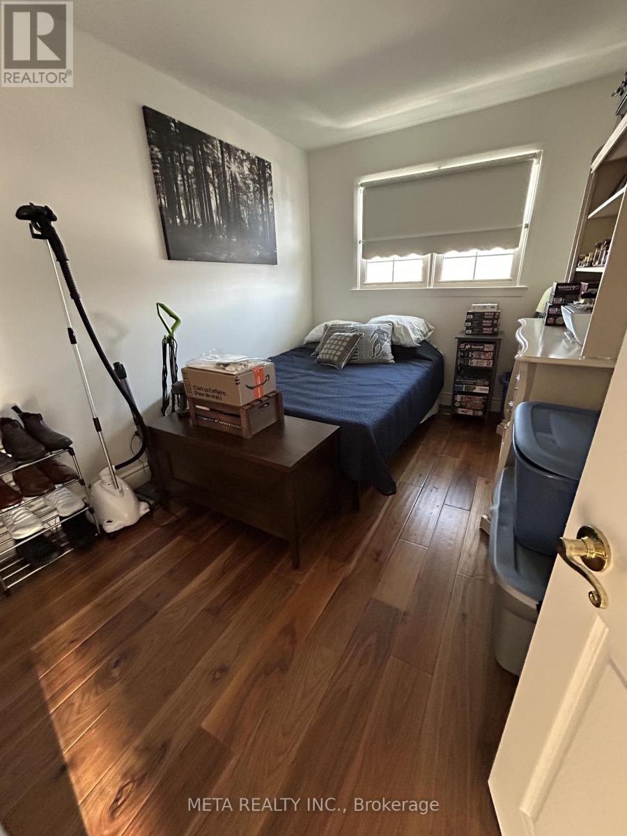 A bedroom with a bed, nightstand, and window.