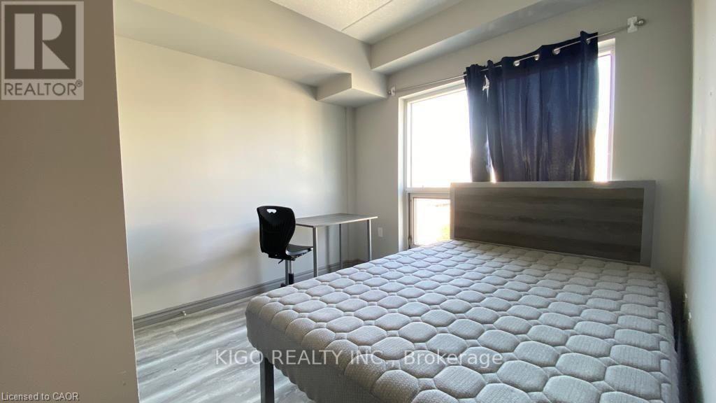 A bedroom with a large bed and a small table.
