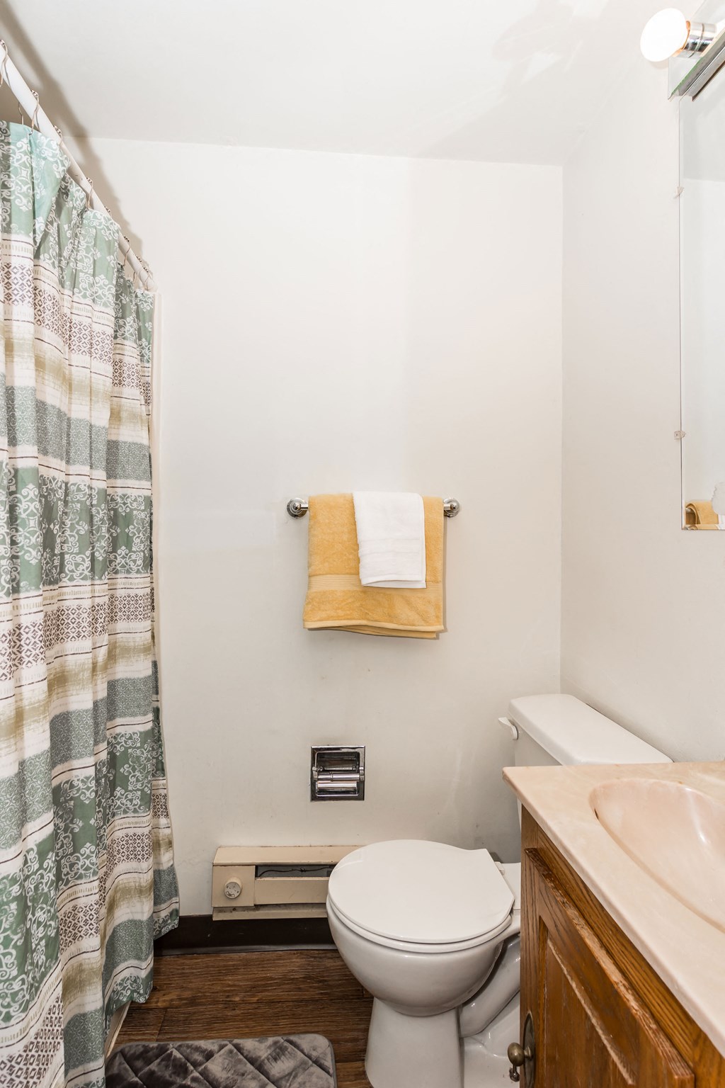 a small bathroom with a toilet and a shower curtain
