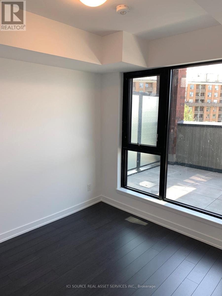 A room with a window and a view of a building outside.