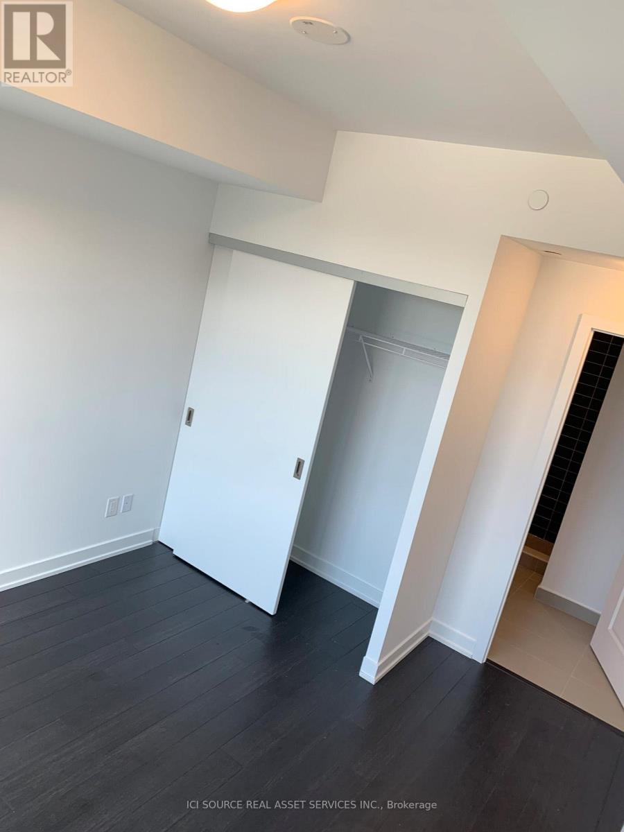 A room with a white door and a black floor.
