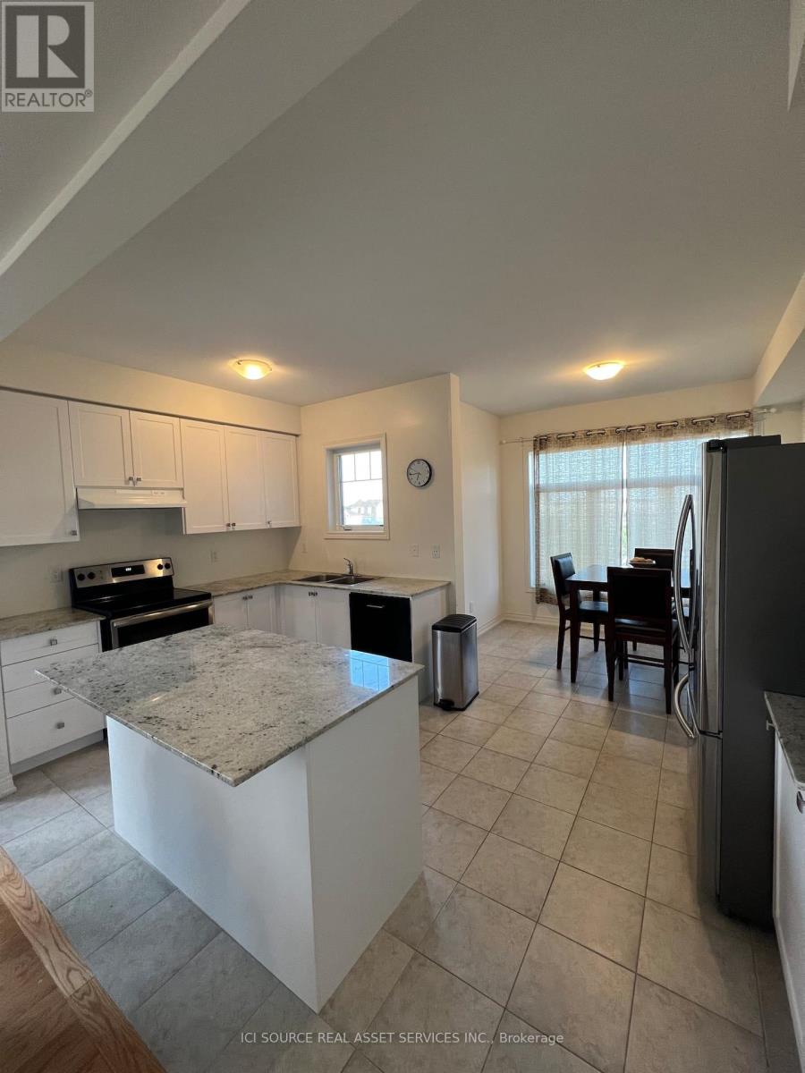 A kitchen with granite countertops and white cabinets.