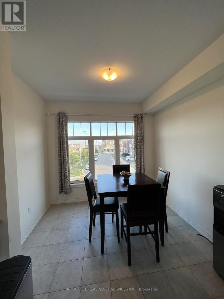 A dining room with a table and chairs.