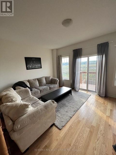 A living room with a grey couch and a black coffee table.