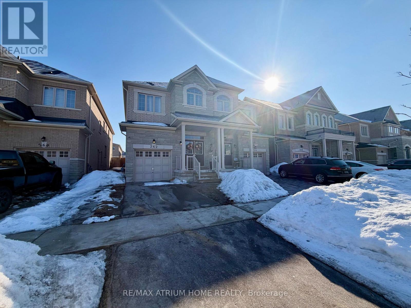 A sunny day in a residential area with houses and cars.