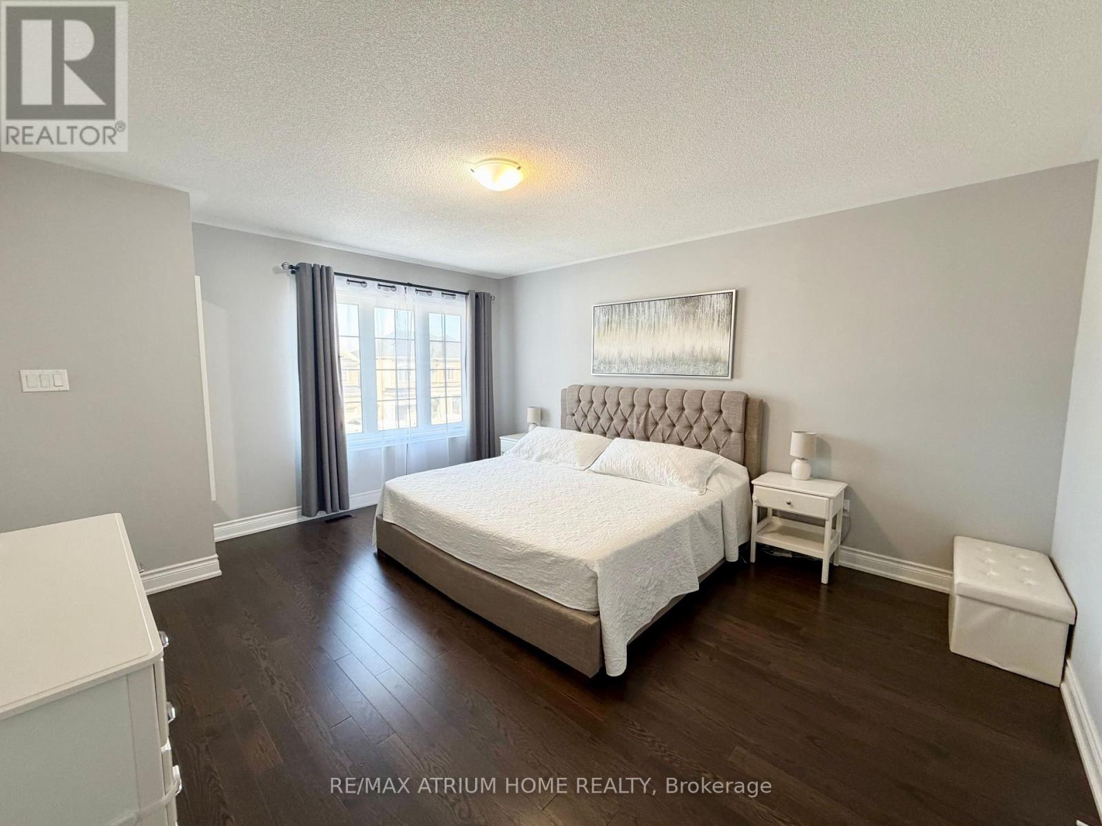 A bedroom with a large bed and a nightstand.