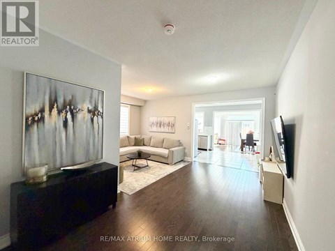 A living room with a couch, a coffee table, and a painting on the wall.