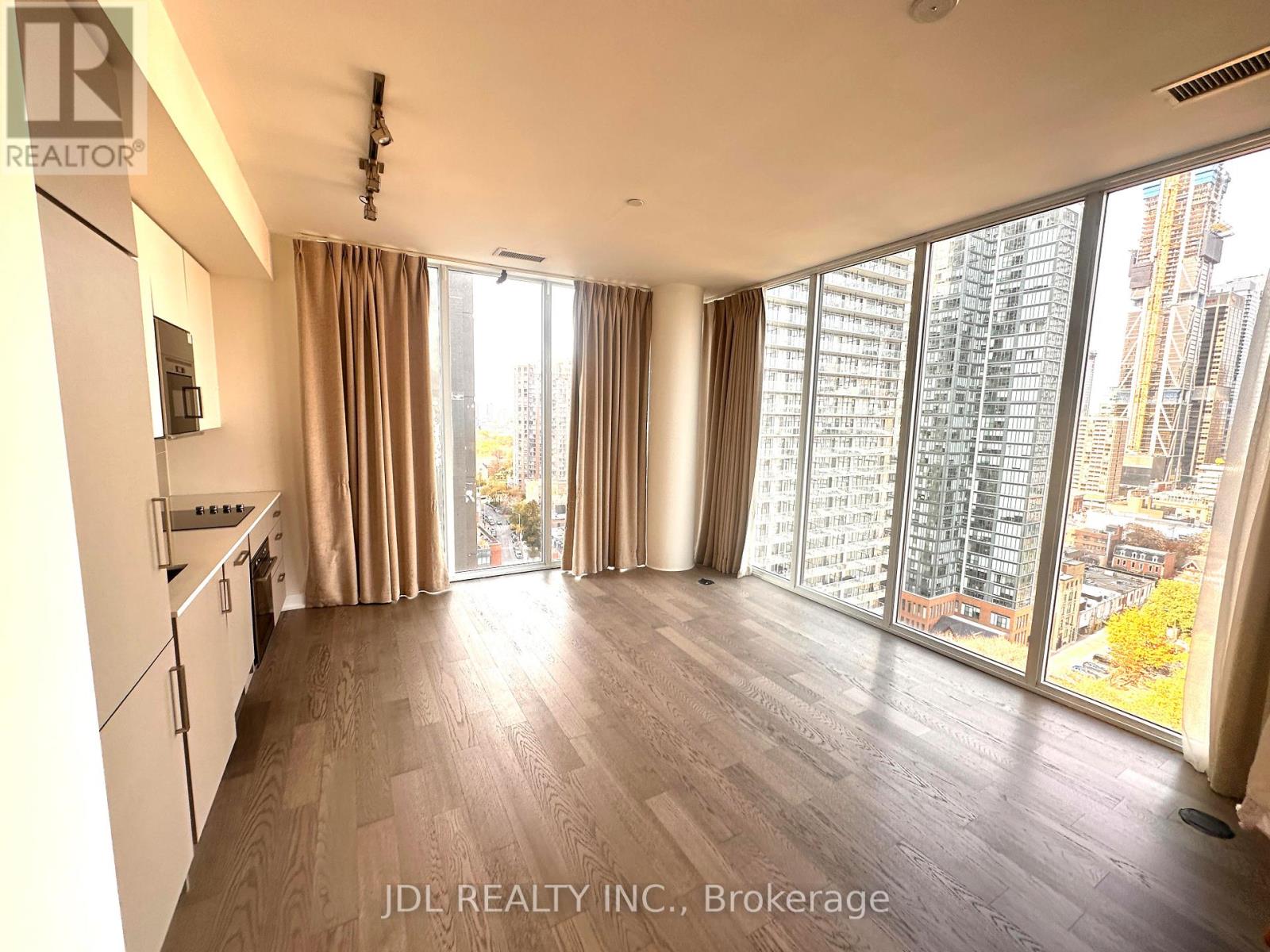 A spacious kitchen and living room with a view of the city.